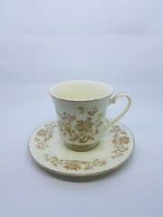 Sugar bowl with flower, tea cup and small jug for milk.