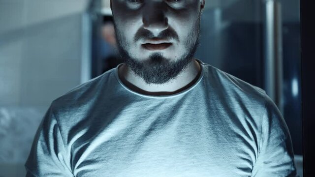 Portrait of Psycho in Blue Light. Grimace Twisted Maniac Crazy. Concept of Fear, Mad Men. Closer Look at the Camera.
