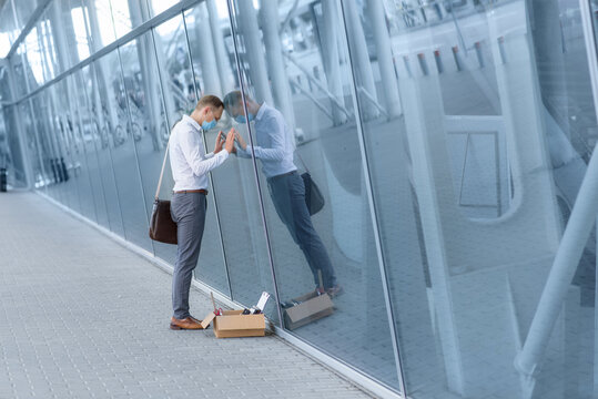 Dismissal of an employee due to a coronavirus epidemic. Dismissed employee sper against the wall of the office head.