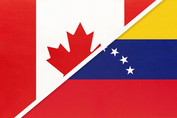 Fototapeta premium Canada and Venezuela, symbol of national flags from textile. Championship between two American countries.