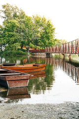 Fototapeta na wymiar Boats on the lake in summer near the bridge
