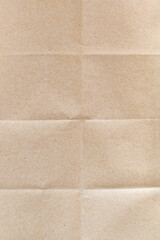 Close-up of the surface of wrapping craft paper with wrinkled lines and shadows. Empty texture...