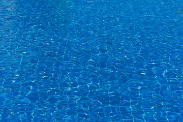 blue swimming pool with sunny reflections abstract for background.