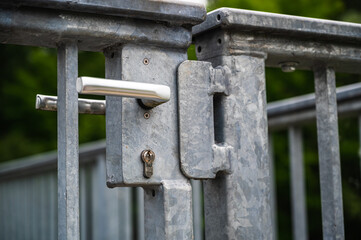 A closeup shot of heavy metal locked gates on a blurred background