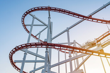 tracks of Roller coaster against blue sky, Perspective Concept