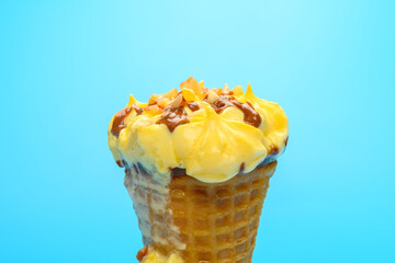 blueberry and cheese flavor ice cream cone melting on blue background