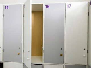 Empty white drawers in the locker room for clothes and things indoors.