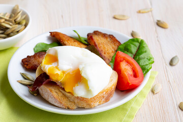 Poached egg on a bruschetta with shallow greens. KETO diet concept