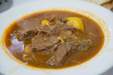 Traditional Yemenite beef soup, served in a white bowl 