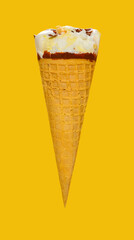 side view vanilla flaovr ice cream cone with a small bite on a yellow background