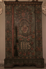 An old vintage wardrobe made of wood stands in the hallway
