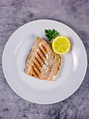 Fish salmon with lemon on a plate