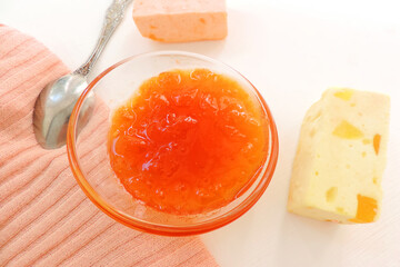   apricot jam in a glass bowl and fruit candy, delicious dessert       