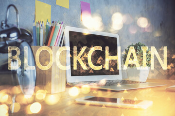 Double exposure of blockchain and crypto economy theme hologram and table with computer background....