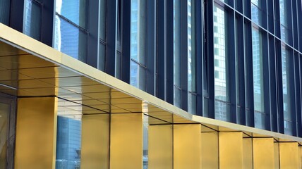 Combination of metal and glass wall material. Steel facade on columns. Abstract modern architecture. High-tech minimalist office building. Contemporary business architecture abstract fragment.