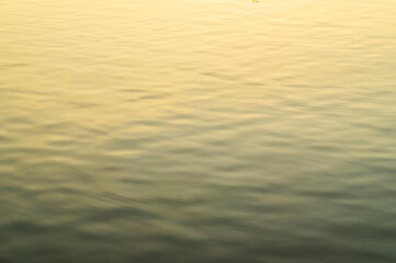 Soft clear water with reflection of sunset.