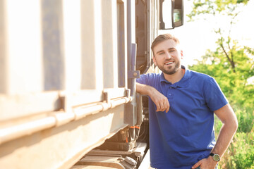 Male driver near big truck outdoors