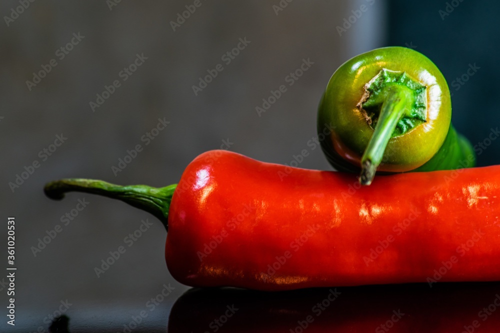 Sticker closeup of red and green chilli pepper on the table under the lights on a blurry background