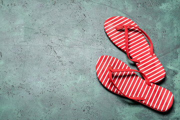 Stylish flip-flops on color background
