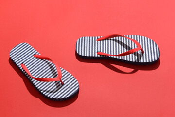 Stylish flip-flops on color background