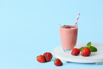 Glass of tasty strawberry smoothie on color background