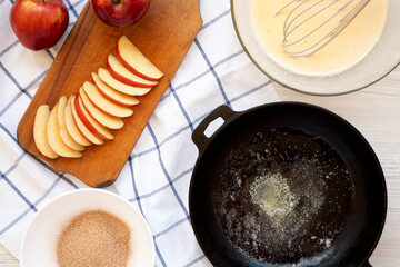 Cooking Apple Dutch Pannekoek Pancake on a white wooden background, top view. Overhead, from above.