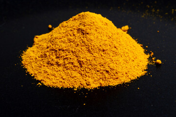 Curry powder in closeup on black background