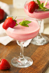 Glass of tasty strawberry smoothie on table
