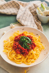 Plate with tasty pasta bolognese on table