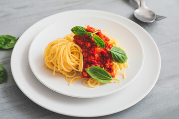 Plate with tasty pasta bolognese on table