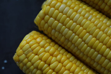 Freshly made fragrant ear of corn with salt. Farm snack of fresh corn. Healthy breakfast and healthy lifestyle concept.