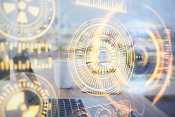 Fototapeta premium Computer on desktop in office with technology theme hologram. Double exposure. Tech concept.