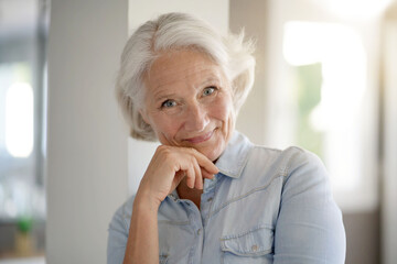 Fototapeta na wymiar Portrait of smiling senior woman with white hair