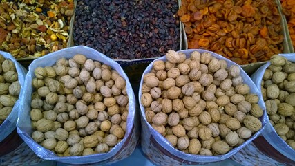 Walnuts and dried fruits for sale in the grocery local farmer market. Nuts for healthy fitness super food. Natural organic product concept. Agricultural fair. 