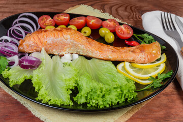 Grilled trout fillet with vegetables, close-up in selective focus