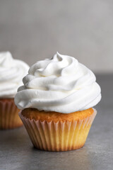 Birthday cream cupcake on a gray background.