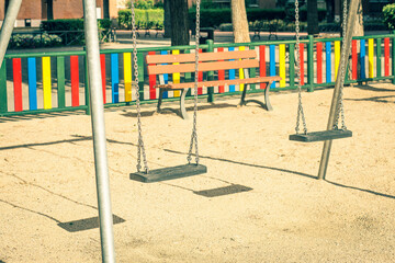 empty swings in a playground due to covid-19 quarantine.coronavirus prevention