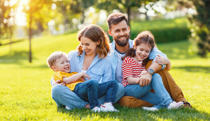 Happy family resting on lawn together.