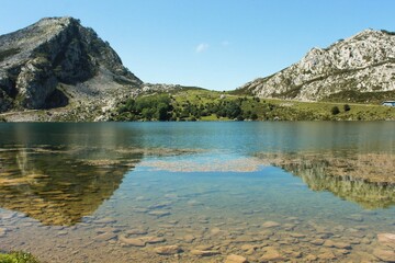 landscape of mountains and a lake with reflections in the water in Peaks of Europe (Asturias, Spain) / paisaje de montañas y un río con reflejos en el agua en Picos de Europa