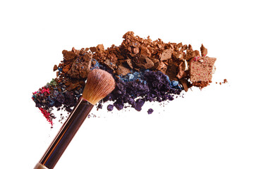 Broken scattered mix of eye shadows with make-up brush