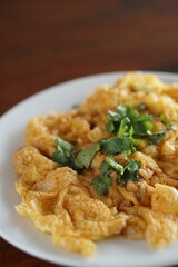 Angle view of Omelet top with coriander on wood table.(Thai style)