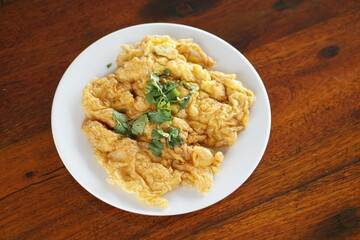 Top view of Omelet and top with coriander on wood table.(Thai style)