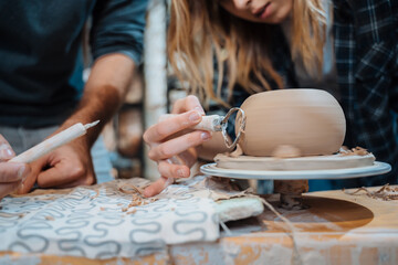 Fototapeta na wymiar Making a handmade clay pot. Pottery lesson, hobby.