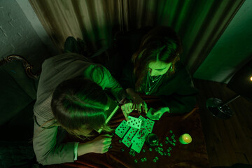 Fortune teller forecasting the future to woman with cards