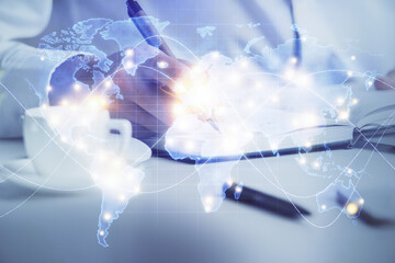 Double exposure of hands and notepad with business icons.