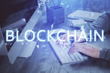 Blockchain theme hud with businessman working on computer on background. Concept of crypto chain....