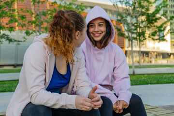 girls chatting and resting after training session. fitness, healthy lifestyle concept