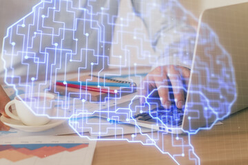 Businessman with computer background with brain theme hologram. Concept of brainstorm. Multi exposure.
