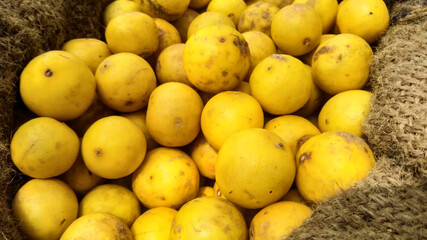 indian man sealing yellow lemon on a street market, Indian Vegetable 