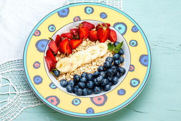Breakfast: oatmeal with bananas, blueberries, strawberries and mint. Beautiful plate.